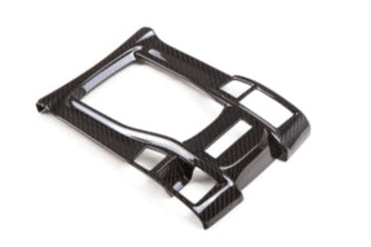 Carbon fiber car interior trim component on a white background with 'REVEL' branding.