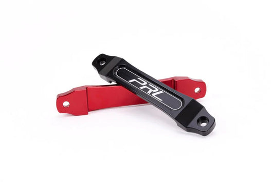 Close up of red and black versions of the PRL Motorsports Billet battery tie down bracket mount for 2006 through 2021 Honda Civic vehicles. Fits battery group size 51R.